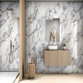 Marble Waves glossy marble effect porcelain tile 60x120cm with flowing grey and gold veining in a modern luxury bathroom.
