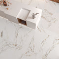 Top-down view of Ayora White Polished porcelain tiles laid on the floor with matching cladded walls, showcasing their glossy marble-effect finish.
