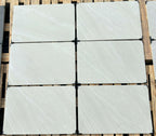 Bright white outdoor porcelain paving tiles 900x600mm on contemporary patio