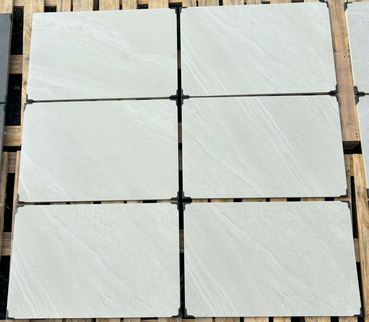 Bright white outdoor porcelain paving tiles 900x600mm on contemporary patio