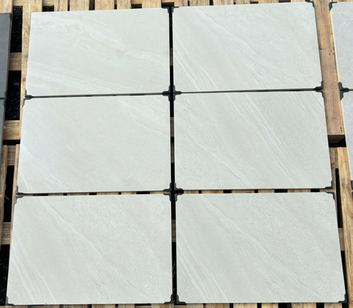 Bright white outdoor porcelain paving tiles 900x600mm on contemporary patio