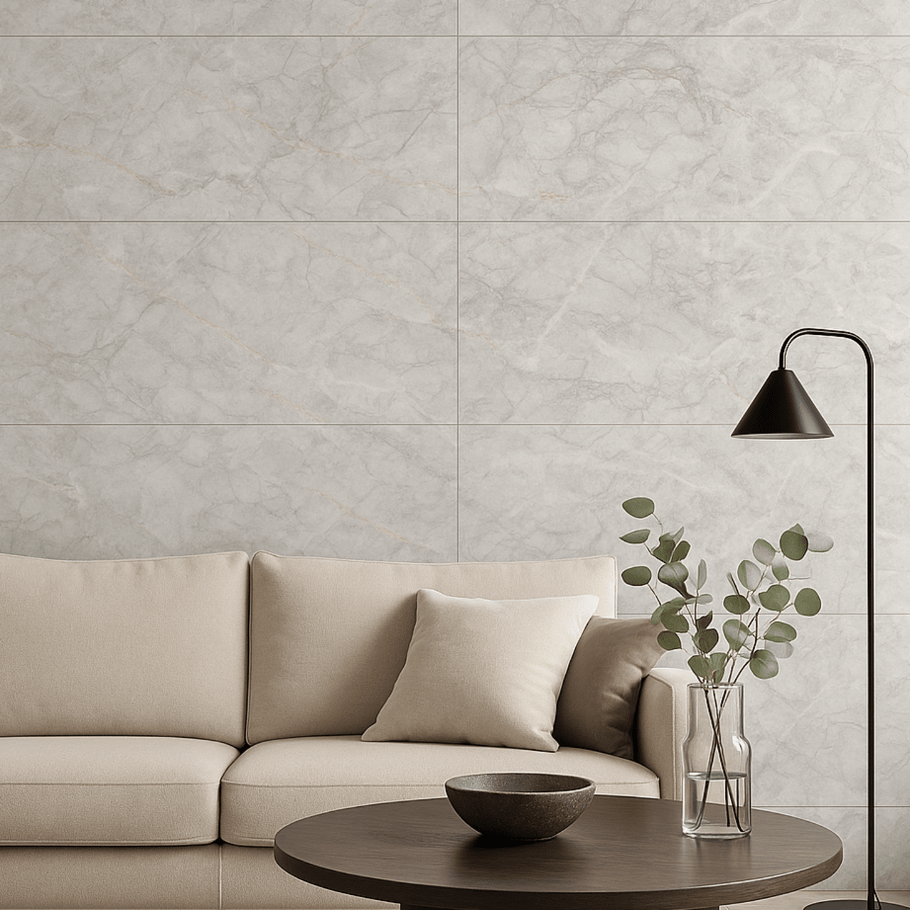 Living room interior featuring Celeste Grey Endless Marble Gloss Tiles on the wall, styled with a neutral beige sofa, black floor lamp, and round wooden coffee table with minimalist decor.