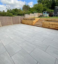 Classic grey outdoor porcelain paving tiles 900x600mm laid on modern UK patio