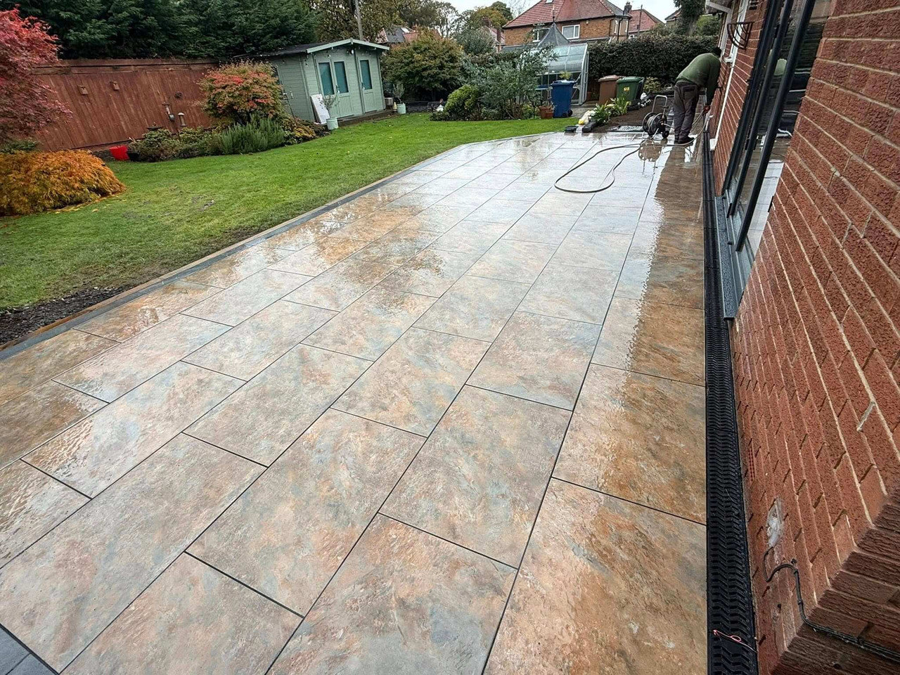 Rustic copper slate effect outdoor porcelain paving tiles 900x600mm on garden terrace