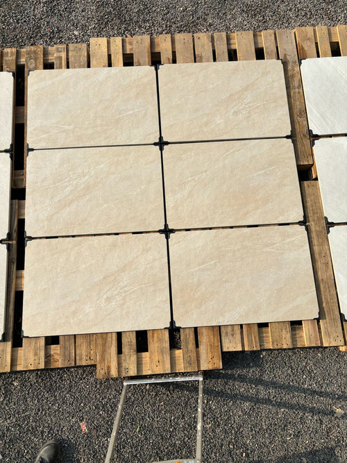 Heritage cream veined outdoor porcelain paving tiles 900x600mm laid on a UK garden patio