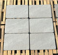 Coastal light grey outdoor porcelain paving tiles 900x600mm laid on a UK garden patio