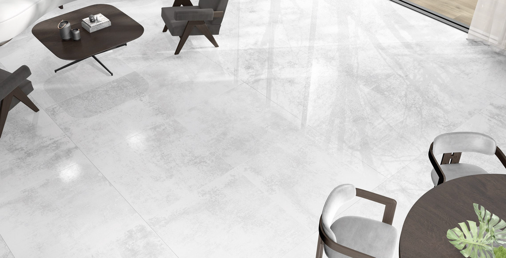 Modern living space with Crystal White Lapatto porcelain tiles on floor, showcasing soft reflective finish and minimalist style.