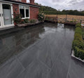Dark anthracite premium outdoor porcelain paving tiles 900x600mm on sophisticated patio