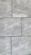 Cloudstone mid grey outdoor porcelain paving tiles 900x600mm laid on a modern UK garden patio