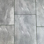 Mid grey speckled porcelain paving slabs 900x600mm in a landscaped garden terrace