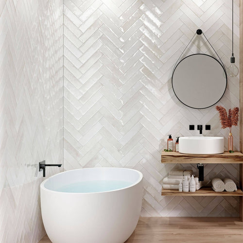 Contemporary bathroom showcasing Edgy White Glossy Metro Tiles in a herringbone pattern, paired with wood-effect walls and minimalist fixtures.