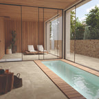 Eterna Beige porcelain tile used in a modern spa space with indoor pool and loungers.