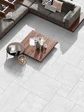 Crisp pearl white outdoor porcelain paving tiles 900x600mm in bright garden setting