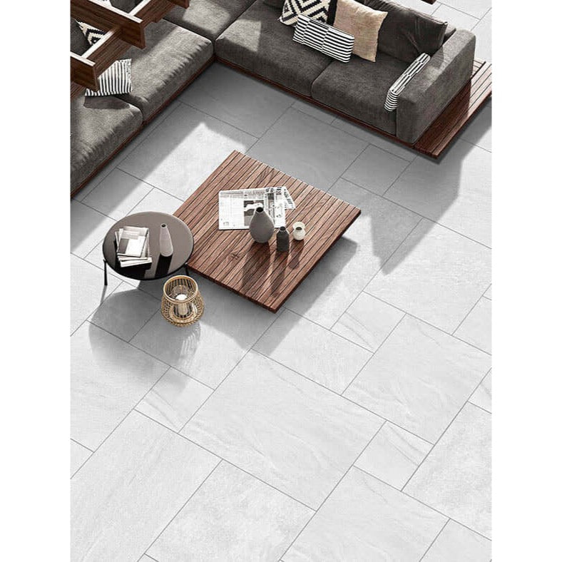Crisp pearl white outdoor porcelain paving tiles 900x600mm in bright garden setting