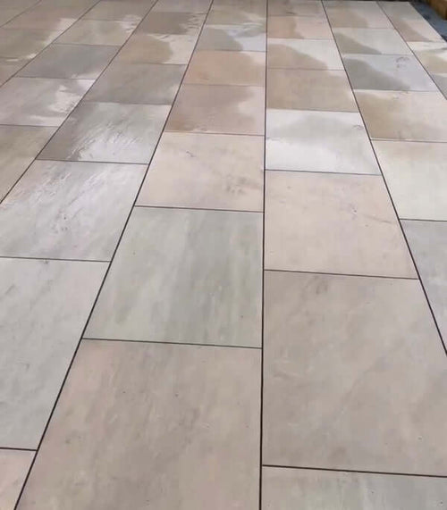Bold forest green outdoor porcelain paving tiles 900x600mm on garden patio