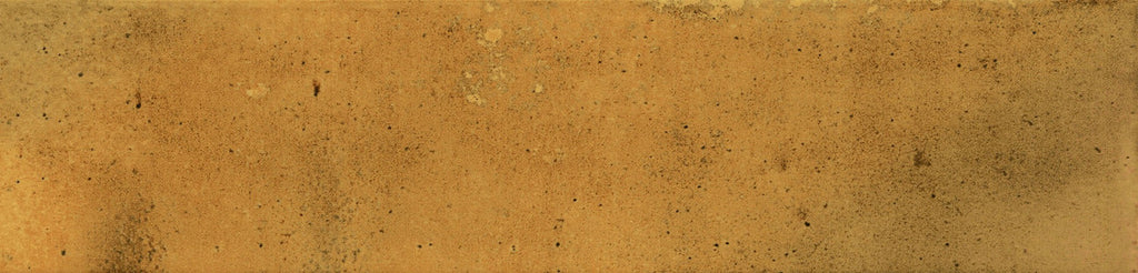 Textured surface of Urban Yellow Glossy Metro Wall Tile with rich golden hues and natural variation under a smooth glazed finish.
