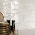 Studio image of Oceania White 6x25cm tile highlighting gloss finish and subtle texture.