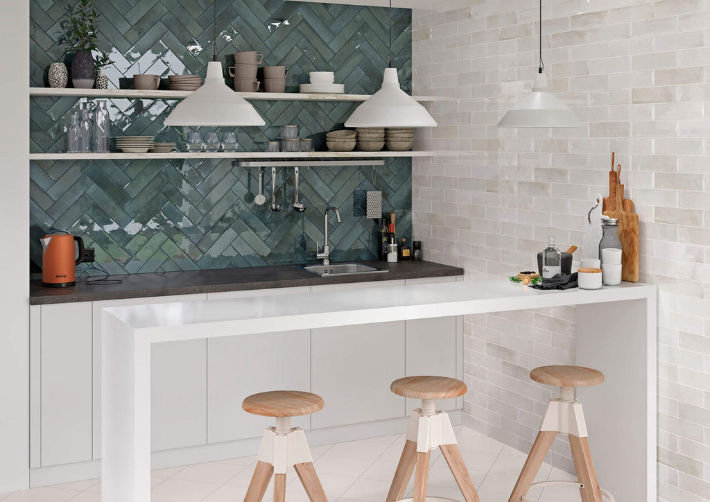 Modern kitchen interior with Urban Blue Glossy Metro Tiles in a herringbone pattern, used as a stylish splashback with contrasting white cabinetry.