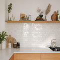 Modern kitchen splashback featuring Oceania White Textured Glossy Metro Tiles in a linear layout beneath open shelving.