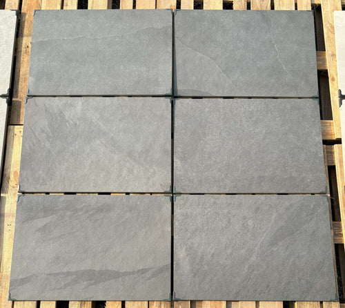 Jet black outdoor porcelain paving tiles 900x600mm on modern UK patio