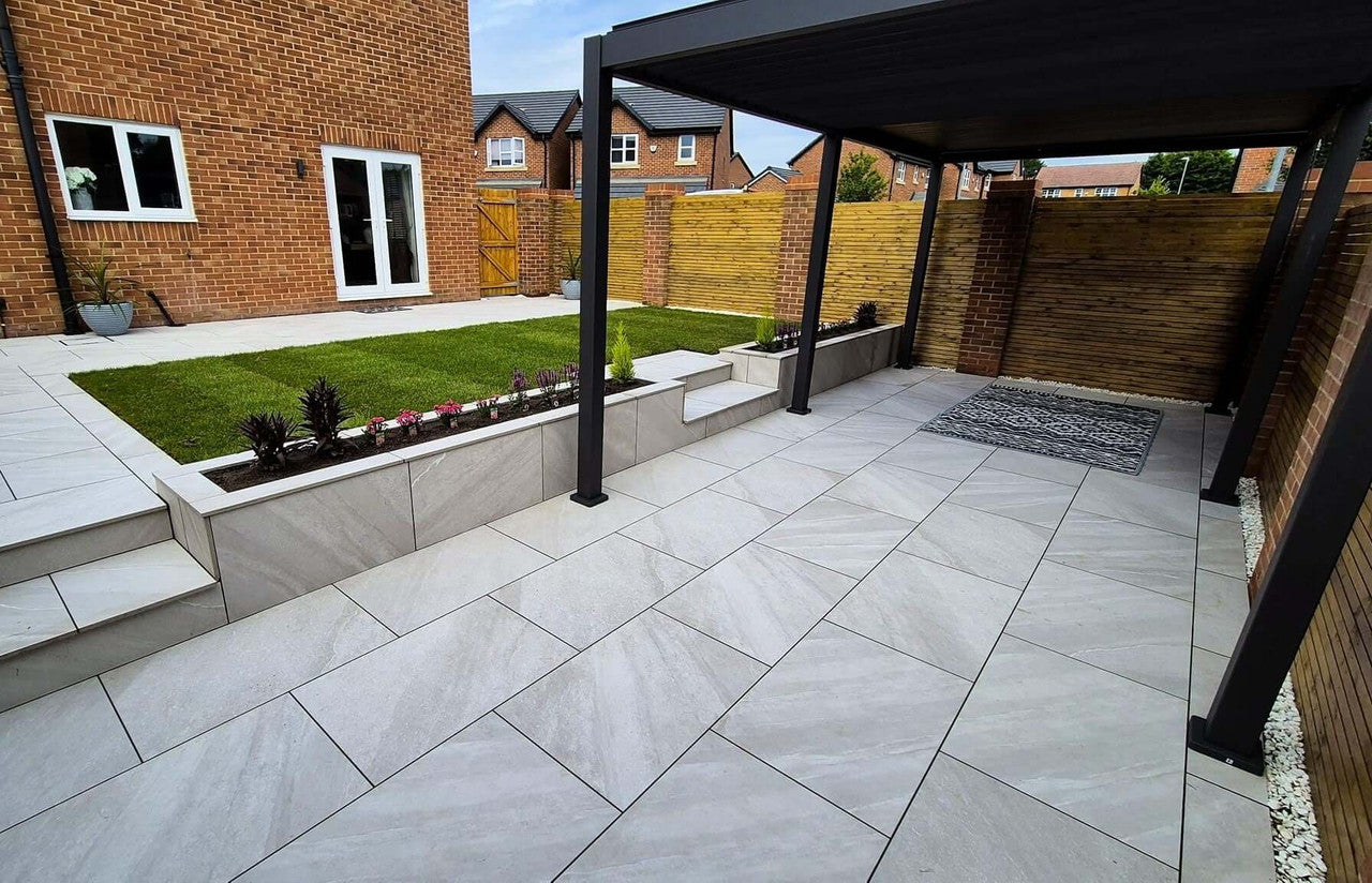 Textured lava grey outdoor porcelain paving tiles 900x600mm on garden patio