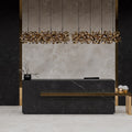Reception area styled with Lithos Mink stone-effect wall and floor tiles, featuring warm lighting and minimalist décor.
