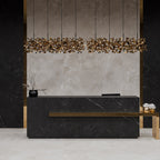 Reception area styled with Lithos Mink stone-effect wall and floor tiles, featuring warm lighting and minimalist décor.