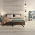 Elegant bedroom featuring Marlon Brown travertino-look porcelain tiles with a matt finish across floor and wall.