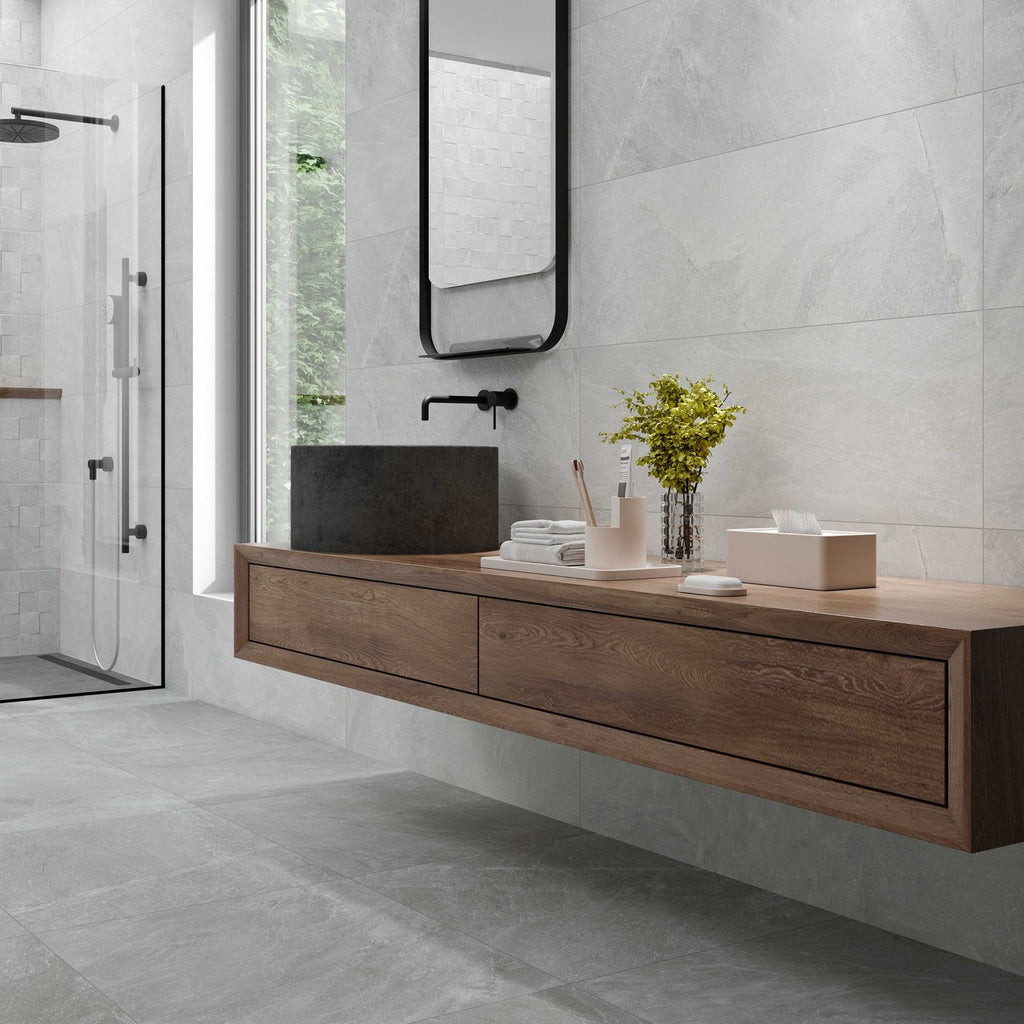 Modern bathroom design showcasing Quarry White tiles across floor and wall, styled with wood vanity and black fixtures.