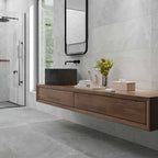 Modern bathroom design showcasing Quarry White tiles across floor and wall, styled with wood vanity and black fixtures.