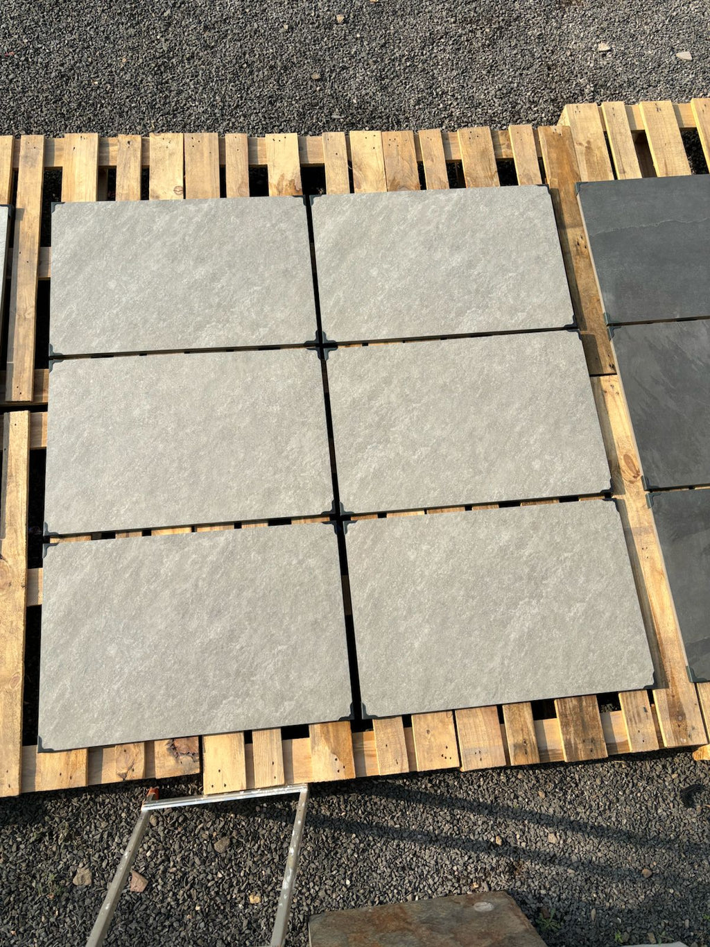 Silver quartz grey outdoor porcelain paving tiles 900x600mm laid on a modern UK patio