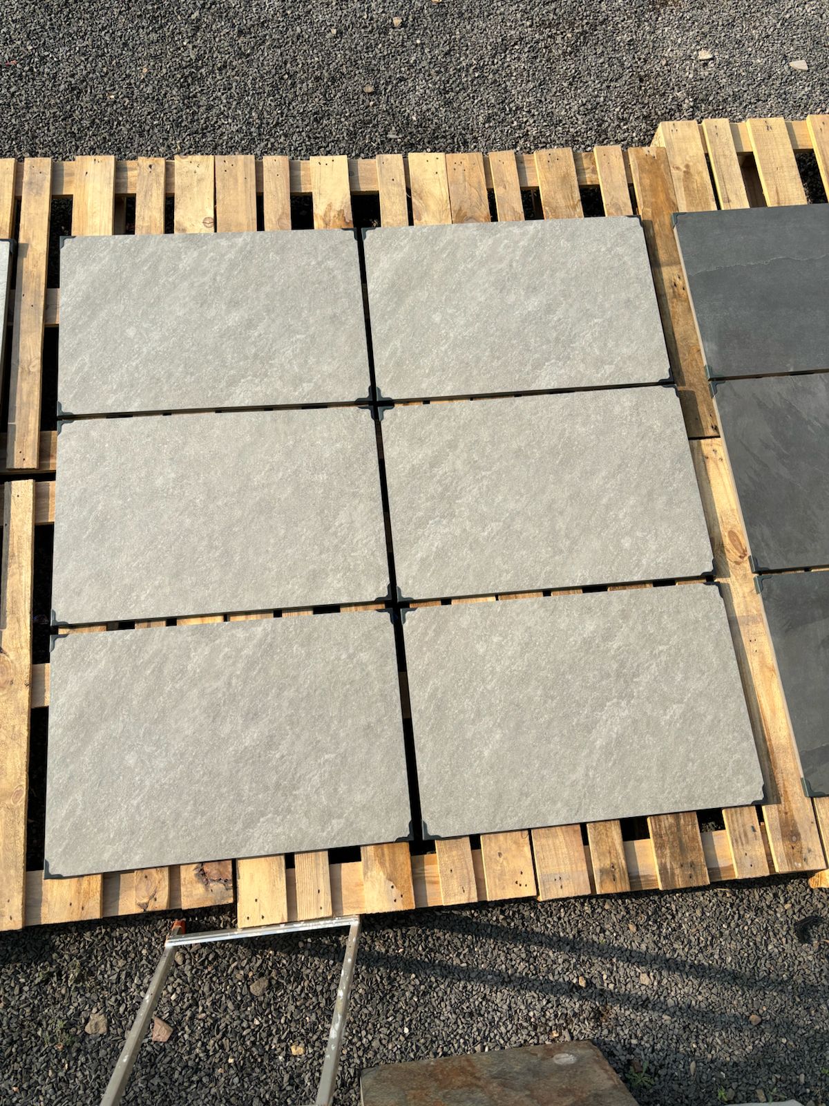 Silver quartz grey outdoor porcelain paving tiles 900x600mm laid on a modern UK patio