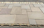 Raj green outdoor porcelain paving slabs 900x600mm in landscaped garden