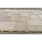Raj green outdoor porcelain paving slabs 900x600mm in landscaped garden