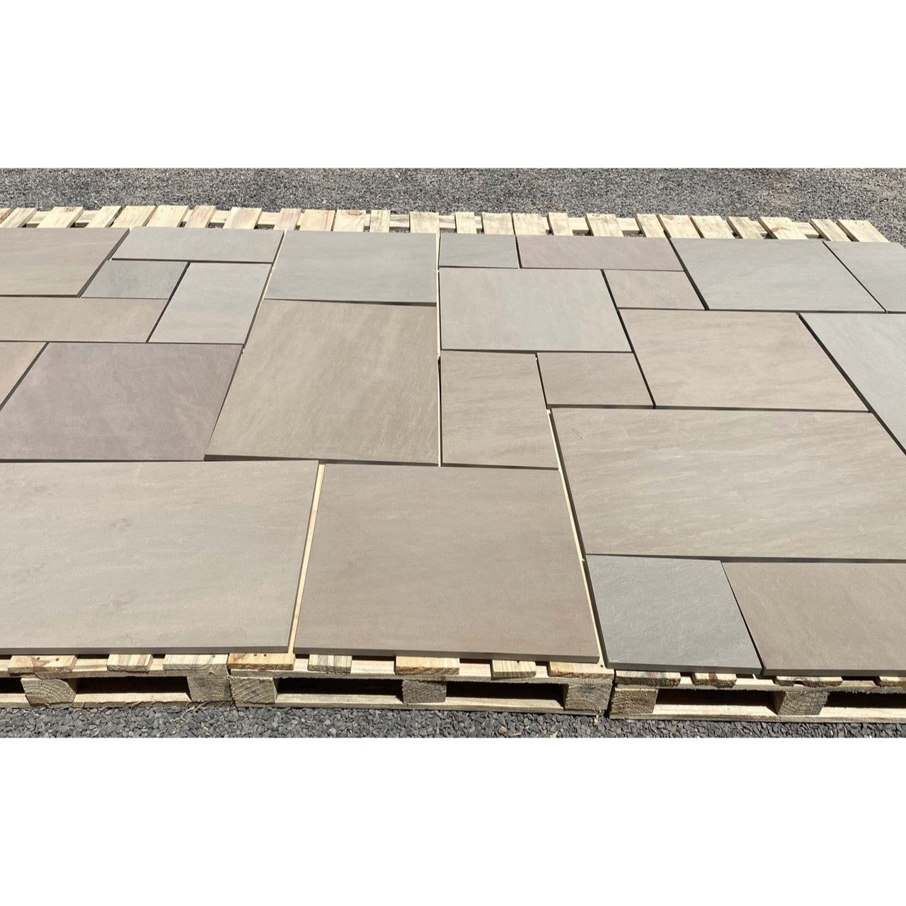 Raj green outdoor porcelain paving slabs 900x600mm in landscaped garden
