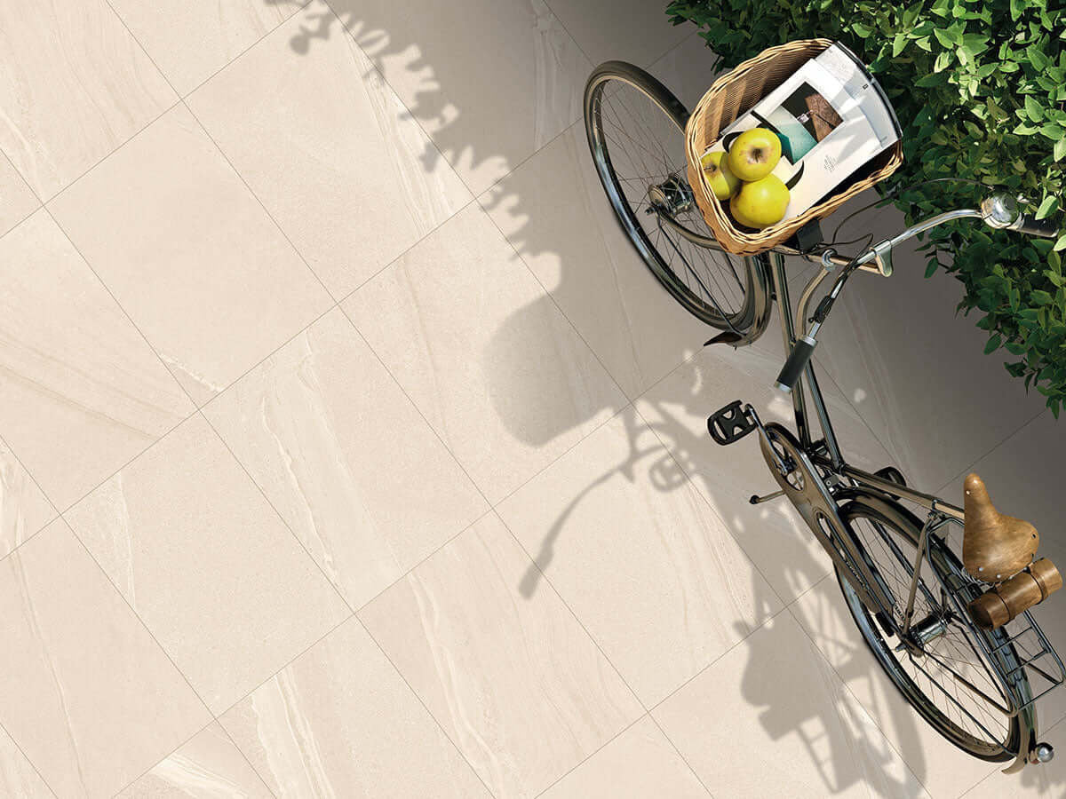 Sand cutstone effect outdoor porcelain paving tiles 900x600mm laid on patio