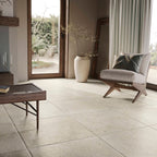 Showcasing the tile's elegant stone-effect finish in a cosy interior space with natural light and wooden accents.