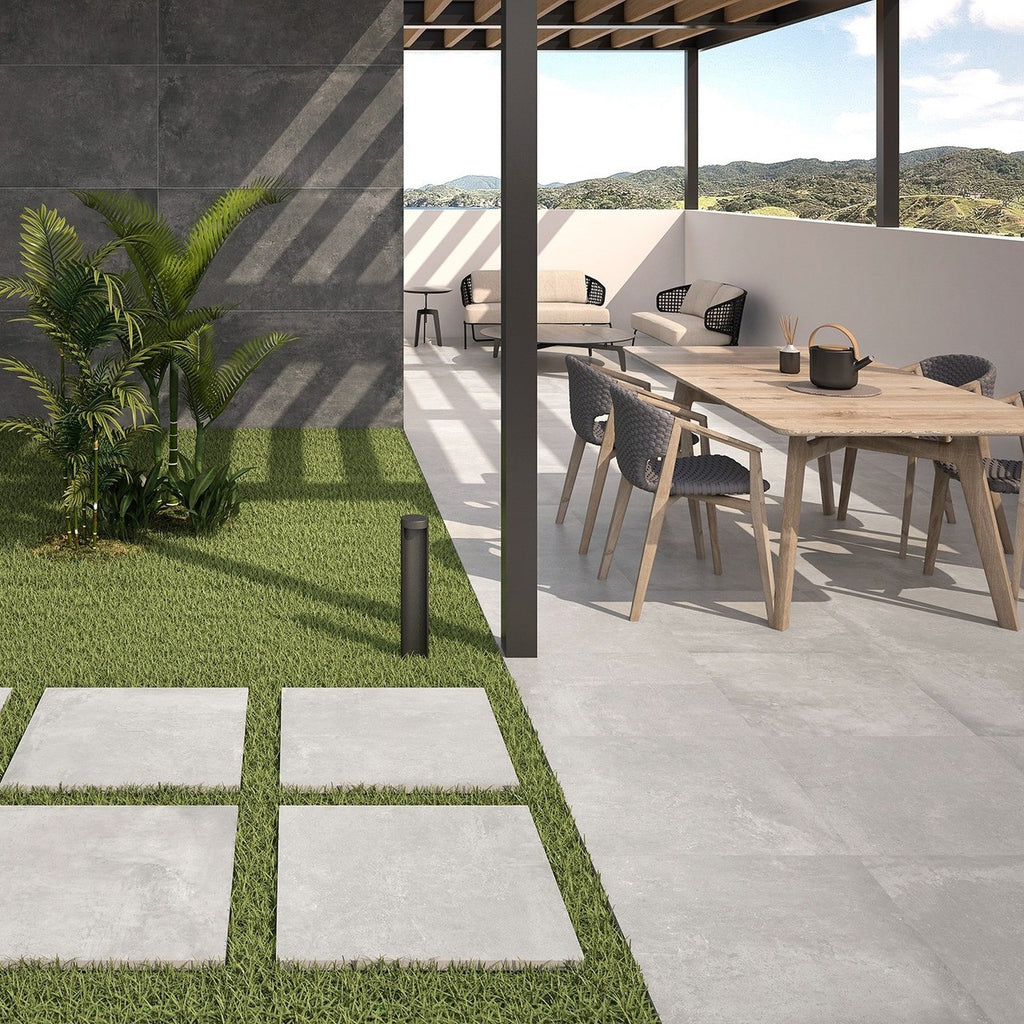 Slater Grey Outdoor Tile styled on a modern patio with garden furniture and planters.