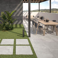 Slater Grey Outdoor Tile styled on a modern patio with garden furniture and planters.