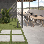 Slater Grey Outdoor Tile styled on a modern patio with garden furniture and planters.