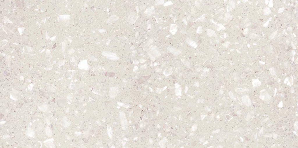 Close-up view of Veneto White Terrazzo Effect Wall & Floor Tile showing its matt finish and soft white base with scattered light grey and ivory stone flecks.