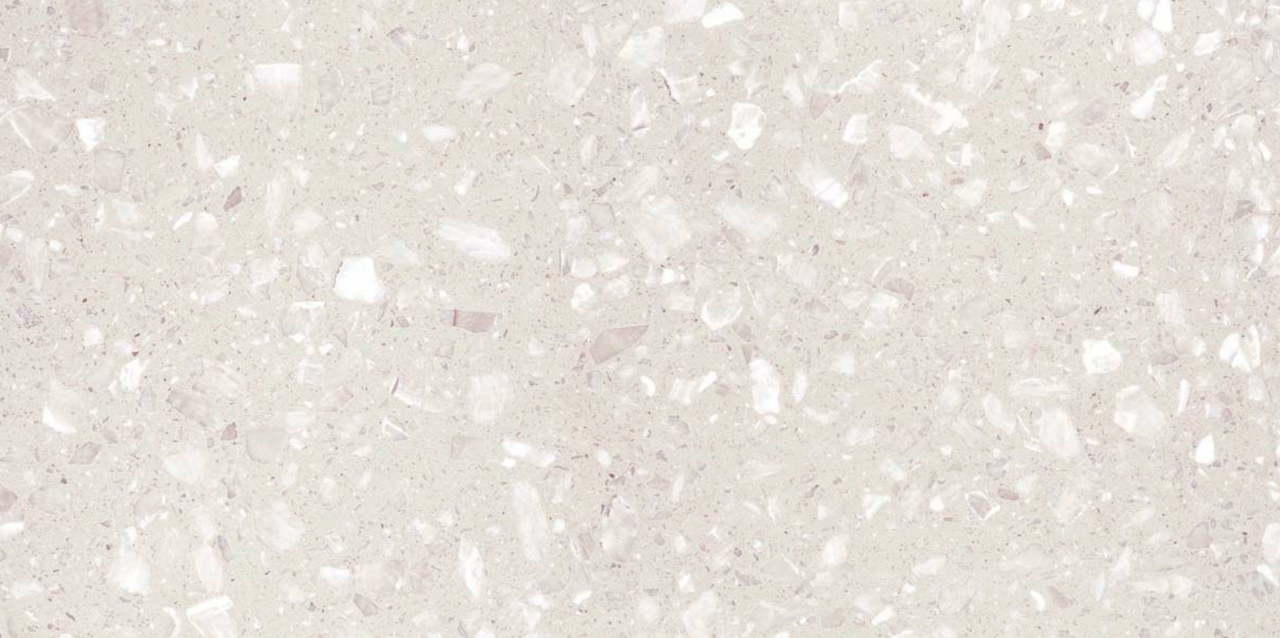 Close-up view of Veneto White Terrazzo Effect Wall & Floor Tile showing its matt finish and soft white base with scattered light grey and ivory stone flecks.