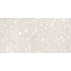 Close-up view of Veneto White Terrazzo Effect Wall & Floor Tile showing its matt finish and soft white base with scattered light grey and ivory stone flecks.