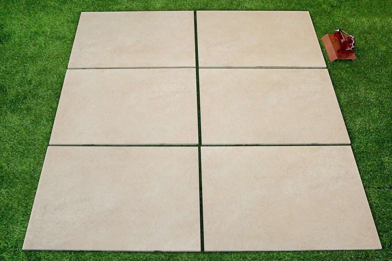 Close-up of beige hammered porcelain paving slab surface texture 900x600mm
