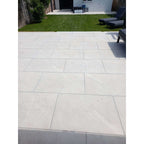 Yorkstone white porcelain garden slabs 900x600mm in landscaped garden