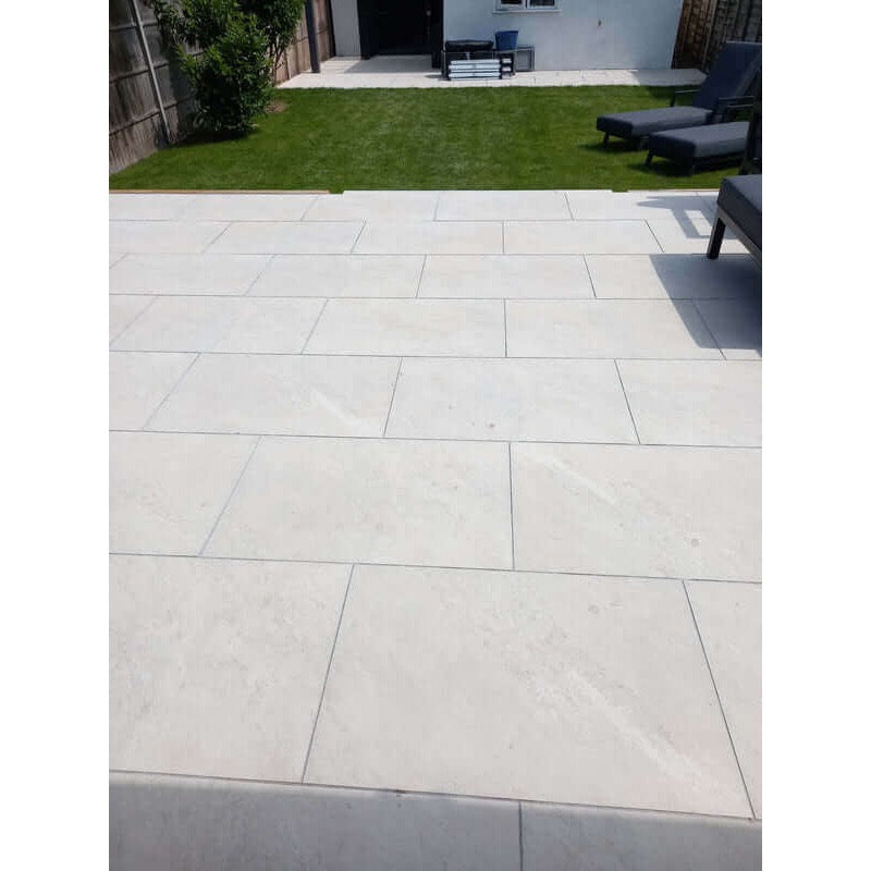 Yorkstone white porcelain garden slabs 900x600mm in landscaped garden